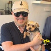 Ricky Gervais cuddles rescue dog Charley at the Hampstead All Dogs Matter pop-up shop