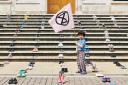 A child rallies against climate change on the steps of Hackney Town Hall