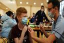 Dean Morrison, 13, receives his Covid-19 vaccine from student nurse Anthony McLaughlin during a vaccination clinic