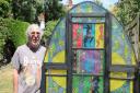 Temple Fortune artist Michael Berg with his stained glass window made from chicken wire