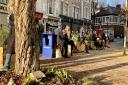 People sitting on the CIL-funded planters at Belsize Village. Picture: Linda Grove.