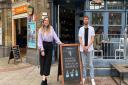 Georgina McGivern, Camden Clean Air programme manager, and Luke Candler, partnerships executive for hospitality businesses, standing outside one of their members Hidden Coffee. Picture: Camden Clean Air