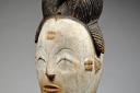 Okuyi mask of the Punu tribe of Gabon, Early 1900s - circa 1920, Wood, white kaolin, yellow ochre, black dyed coiffure, 36cm, from Gabon.