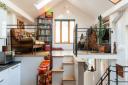 A space-saving staircase leads from the kitchen to a mezzanine-style sitting room