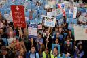 Demonstrators listen to speeches in Waterloo Place during the 'Let's Save the NHS' rally and protest march by junior doctors in London.