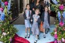 A parent and pupils take to the red carpet during the school run.