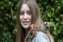 Diving master Indigo Bolandrini, 12, pictured with her pet monkey JoJo. Picture: Nigel Sutton.