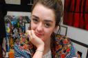 Actress Maisie Williams signs a portrait of herself at Zebra One Gallery NW3. Picture: Polly Hancock