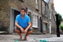 Giles Coren on Little Green Street, Kentish Town, surrounded by disguarded bags of dog poo. Picture: Polly Hancock
