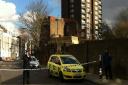 The man is hanging from a fourth floor window of Palgrave House flats in Hampstead