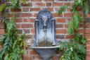 Water doesnt have to be the prominent focal point of your garden, should you wish to install subtler hints here and there (like in the instance of this semi-Gothic goat head wall fountain)