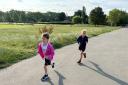 Lolita Oakes and Juliet Deilinger, both aged 7, are running a marathon to raise money for Lolita's mum