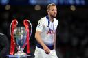 Harry Kane walks past the Champions League trophy after Tottenham's final defeat in 2019