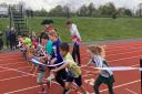 Quad Kids members cross the Parliament Hill athletics track ribbon with Michael Mainelli, Lord Mayor of the City of London
