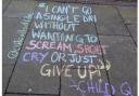 A quote from Child Q, a Black schoolgirl who was strip searched by police, is scrawled into a Hackney pavement
