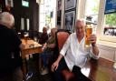 Landlord Jimmy McGrath joins customers for a pint inside King William IV in Hampstead High Street. Picture: Polly Hancock
