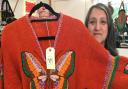 Sarah Khan with a vintage jumper for sale in her shop SK Vintage in Kentish Town