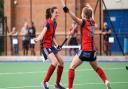 Emily Douglas and Esme Burge of Hampstead and Westminster celebrate a goal against Wimbledon