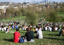 People enjoy the warm weather and sunshine on Primrose Hill