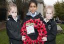 Emma,Nathan and Summer, four-year-old pupils from Hampstead Hill School, lay down a wreath at Hampstead War Memorial. Picture: Nigel Sutton