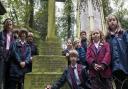 Pupils from Highgate Junior School lay a poppy and cross on the grave of Murray Stuart Pound, a head boy who died in the First World War, at Highgate Cemetery.  Picture: Nigel Sutton