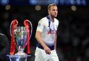 Harry Kane walks past the Champions League trophy after Tottenham's final defeat in 2019