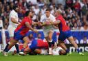 England's Owen Farrell is tackled by Chile's Salvador Lues (left) and Ignacio Silva during their Rugby World Cup clash. Image: PA