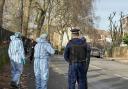 Forensic investigators and an officer at Primrose Hill