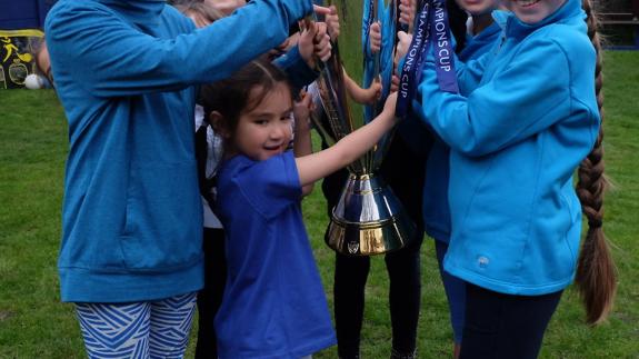 Ham & High: Pupils at The Village Prep in Belsize Park with the Champions Cup won by Saracens last season Ham & High: Pupils at The Village Prep in Belsize Park with the Champions Cup won by Saracens last season
