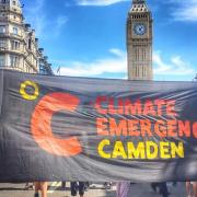 Climate emergency banner at parliament during a coalition march on July 23