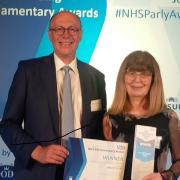 Margaret Harris receiving her award from NHS England national medical director Professor Stephen Powis