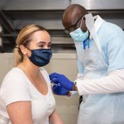 Woman gets a Covid-19 vaccine at an Olympic Park vaccine event.