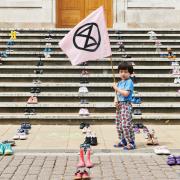 A child rallies against climate change on the steps of Hackney Town Hall