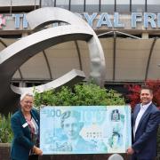 Caroline Clarke, chief executive of the Royal Free London NHS Foundation Trust and Jon Spiers, chief executive of the Royal Free Charity, pictured with a large replica banknote featuring Dr Flora Murray.
