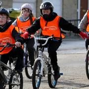 Children learning to ride a bike