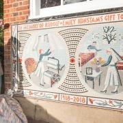 Cllr Oliver Lewis with Romola Jane unveiling the mosaic outside of Konstam Nursery, Highgate Newtown. Picture: Justin Thomas