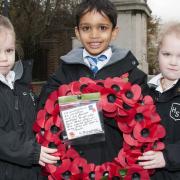 Emma,Nathan and Summer, four-year-old pupils from Hampstead Hill School, lay down a wreath at Hampstead War Memorial. Picture: Nigel Sutton