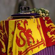 The coffin of Queen Elizabeth II, draped in the Royal Standard with the Imperial State Crown placed on top, lays on the catafalque in Westminster Hall, London, where it will lie in state ahead of her funeral on Monday. Picture date: Wednesday September