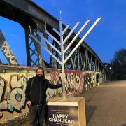 Camden Town's Rabbi Yossi Baitz with the menorah on the bridge at Chalk Farm