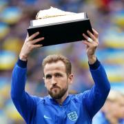 Harry Kane holds up a golden boot for becoming England's all-time record goalscorer ahead of their match against Ukraine at Wembley Stadium
