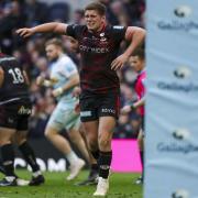 Owen Farrell grimaces with pain after picking up an injury during Saracens' clash with Harlequins at Tottenham Hotspur Stadium