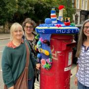 Caroline Chan with fellow knitters ,Catty and Tracey at the post-box in Belsize Park
