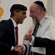 Prime Minister Rishi Sunak (left) and Chief Rabbi Sir Ephraim Mirvis attending Finchley United Synagogue yesterday (October 9)