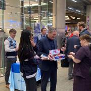 Sir Keir Starmer giving out poppies at Kings Cross Station