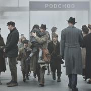 A scene from the film One Life in which Alex Sharp as Trevor Chadwick brings Jewish children from  Prague back to England.