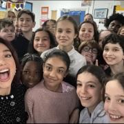 Dua Lipa with pupils at her old school in Hampstead and the DJ Greg James