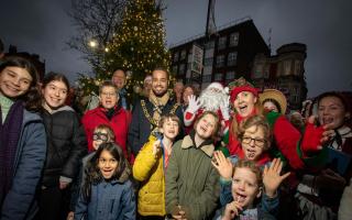 Mayor of Haringey Cllr Adam Jogee switches on the lights on the Christmas Tree in St James Square. Pictured with Cllr Ruth Gordon, Cllr Pippa Connor, local traders, Santa, Elf and children who attended the event.