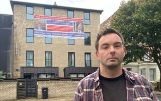 Daniel Bruce and two other first-time buyers have hung a huge banner on their crumbling block of flats in Agar Grove, Camden Town, saying government failures have cost them millions, so the government should bail them out