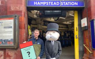 John Keen-Tomlinson, custom games executive at Winning Moves UK, with the Monopoly man at Hampstead Station