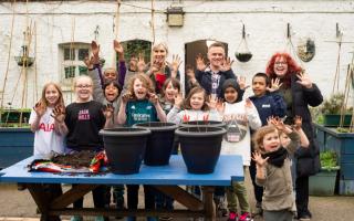 Lauren Child (back middle) joined students at Torriano Primary School to plant the trees